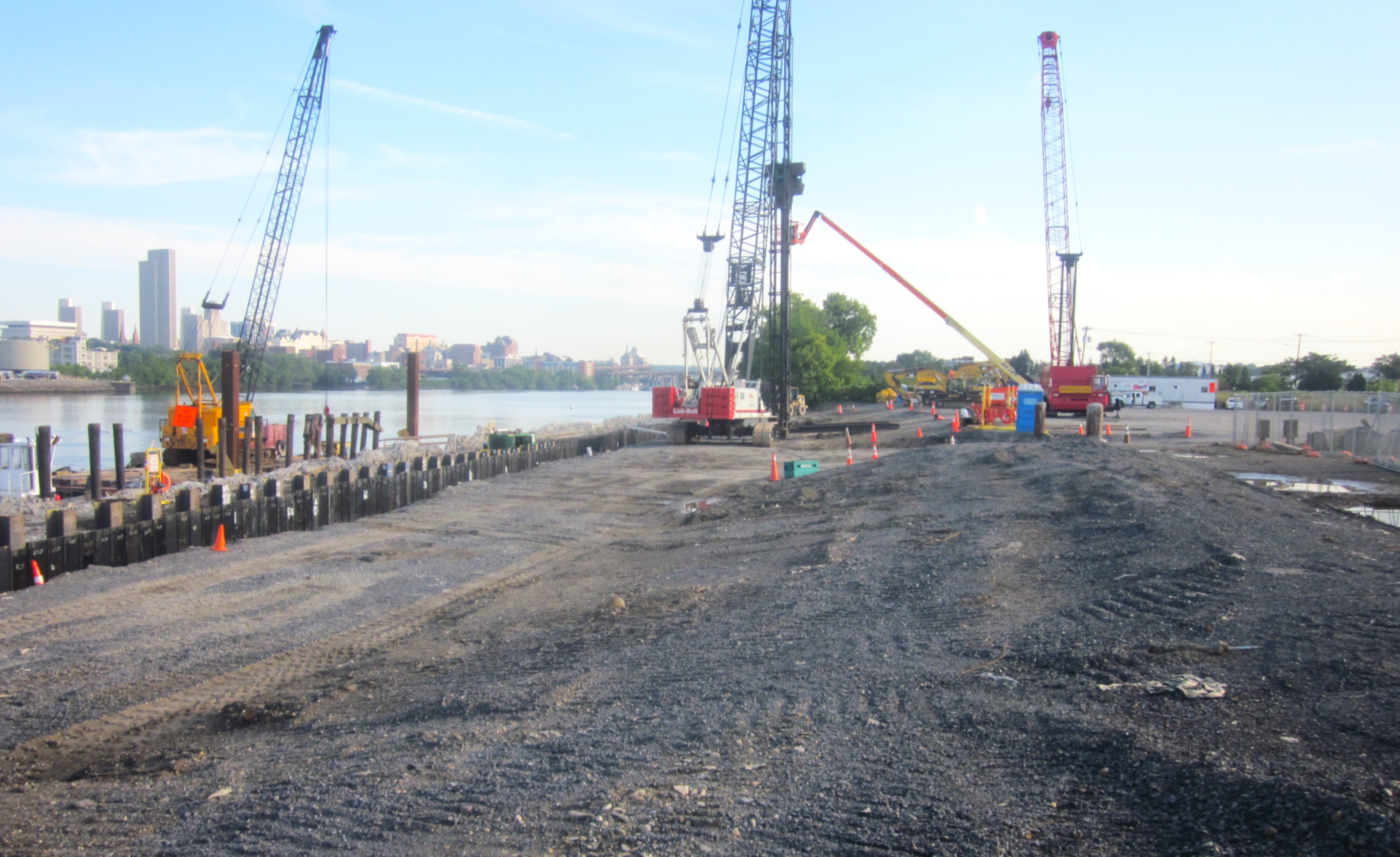 Construction at Rensselaer wharf with city of Albany skyline in the background